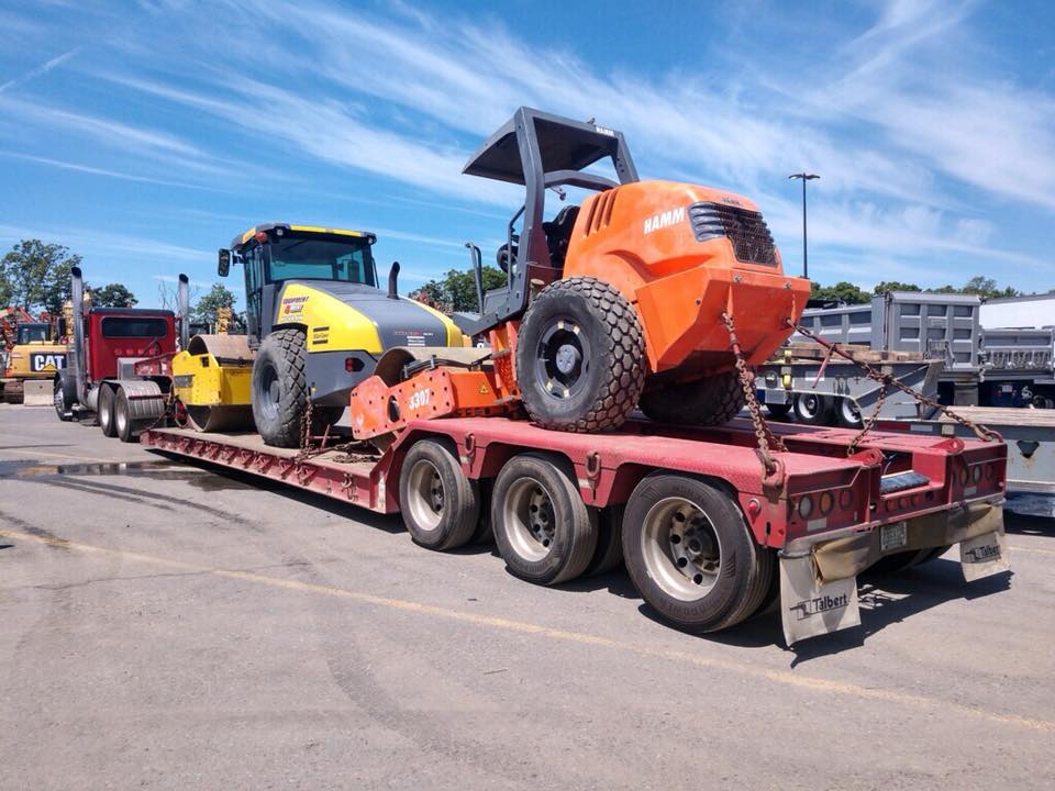 Heavy construction equipment being transported on trailer